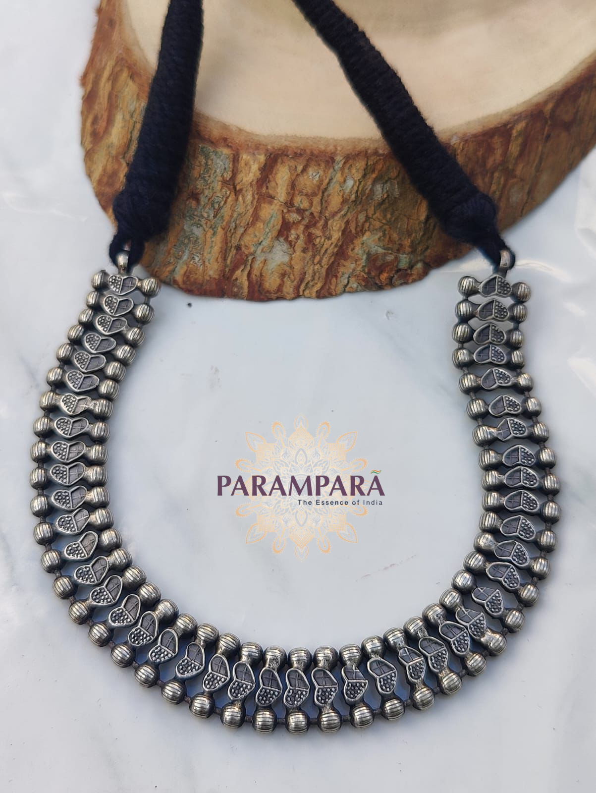 "Handmade oxidized silver necklace with engraved heart-shaped design and adjustable black thread"