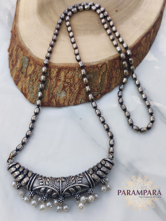 "Oxidized silver beaded necklace with detailed centerpiece and pearl drop accents – handmade Indian jewelry"