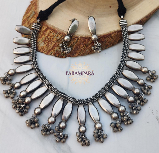 Add a touch of tradition and elegance with this handcrafted oxidized necklace set. Featuring a bold design with intricate beads and matching earrings, it's perfect for casual outings, festive occasions, or unique gift ideas. Lightweight yet durable, this necklace set adds ethnic charm to any outfit.