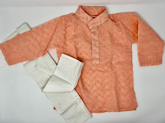 The kurta is made from a Orange woven fabric with simple embroidery patterns.

The pajama is crafted from plain cotton.